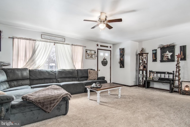 living room with ceiling fan and carpet flooring