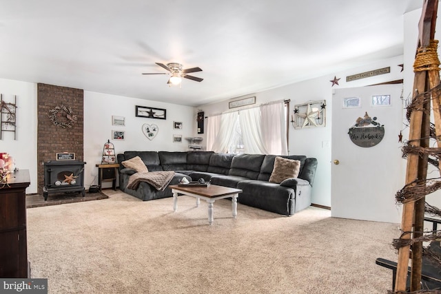 carpeted living room featuring ceiling fan and a wood stove