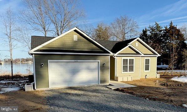 1224 Shore Dr, Colonial Beach, VA 22443 - craftsman inspired home with an attached garage, gravel driveway, and a water view