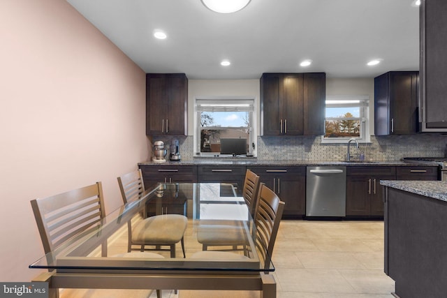 kitchen featuring dark brown cabinets, backsplash, a wealth of natural light, and sink