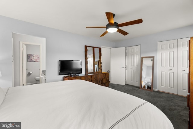 carpeted bedroom with ensuite bath, ceiling fan, and multiple closets