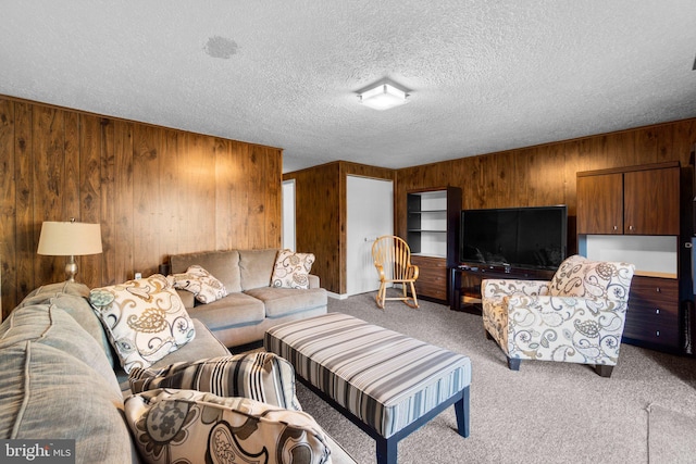 living room featuring a textured ceiling, wood walls, and light carpet