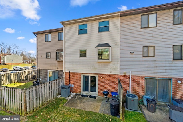 back of property featuring a patio and central AC