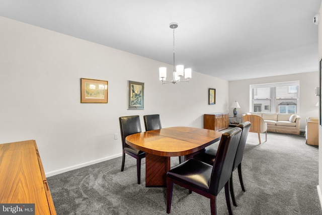 dining area featuring dark colored carpet and an inviting chandelier