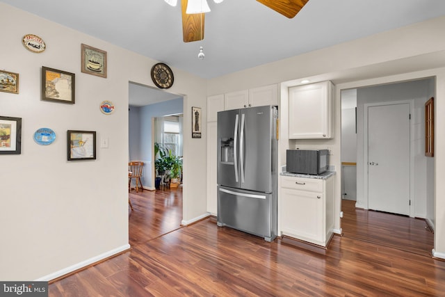 kitchen featuring stone counters, white cabinets, ceiling fan, dark hardwood / wood-style flooring, and stainless steel fridge with ice dispenser