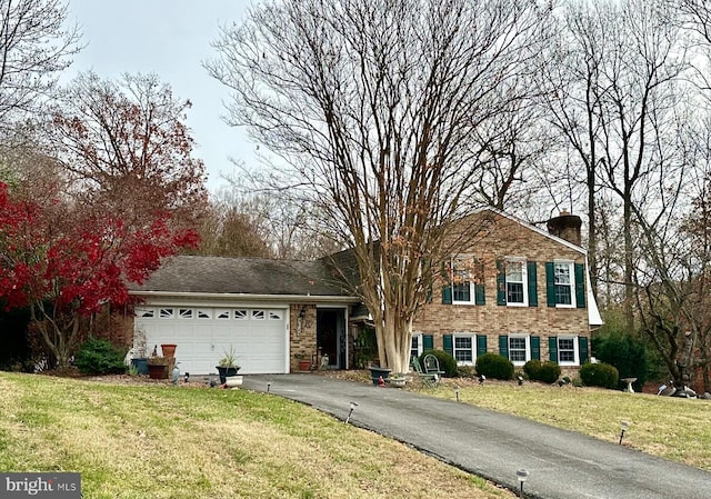 view of front of property featuring a front yard and a garage