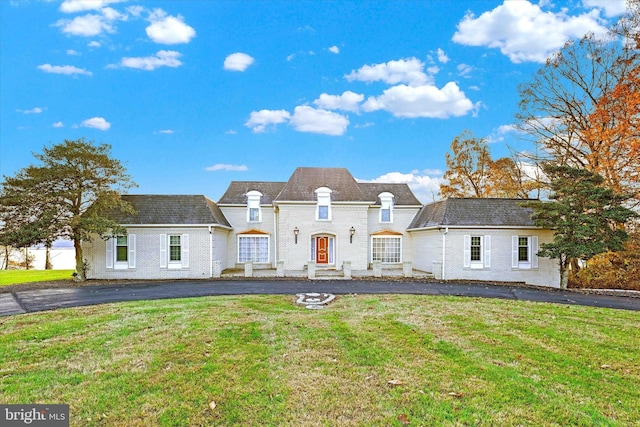 french country inspired facade with a front yard