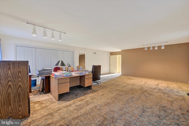 office area with carpet floors and track lighting