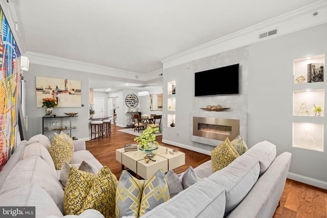 living room with hardwood / wood-style floors and ornamental molding