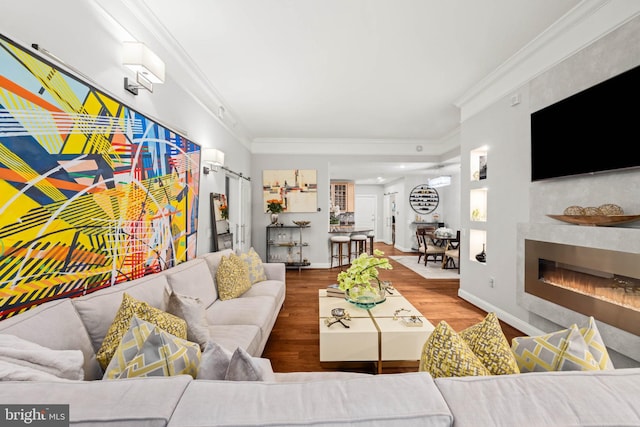 living room with wood-type flooring and crown molding