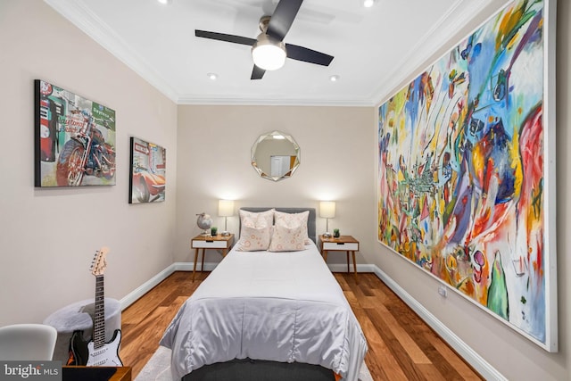 bedroom with wood-type flooring, ceiling fan, and crown molding