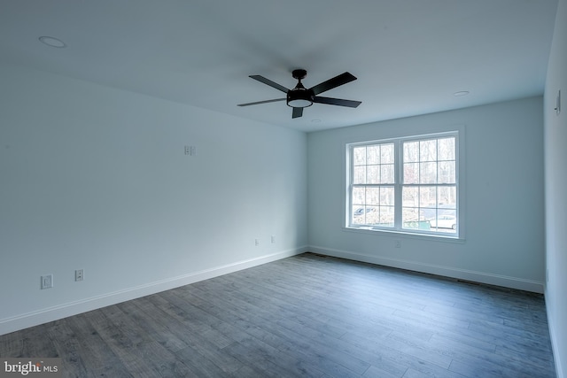 spare room with ceiling fan and hardwood / wood-style flooring