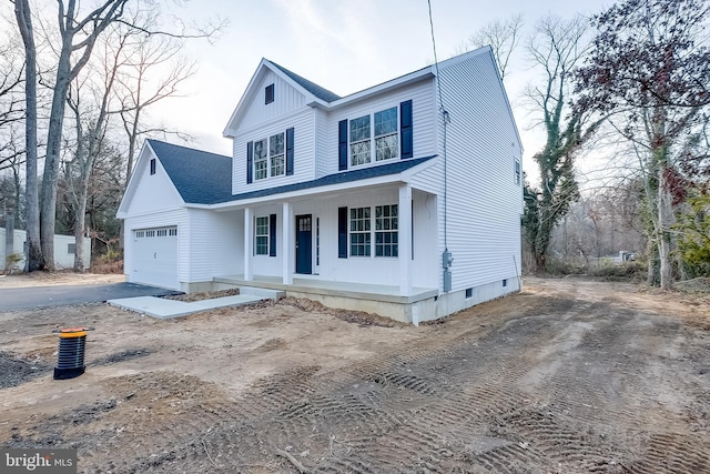 view of front facade featuring covered porch and a garage