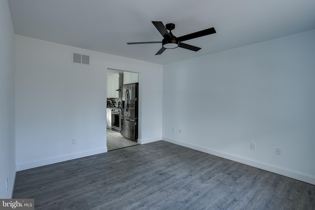 spare room with ceiling fan and dark wood-type flooring