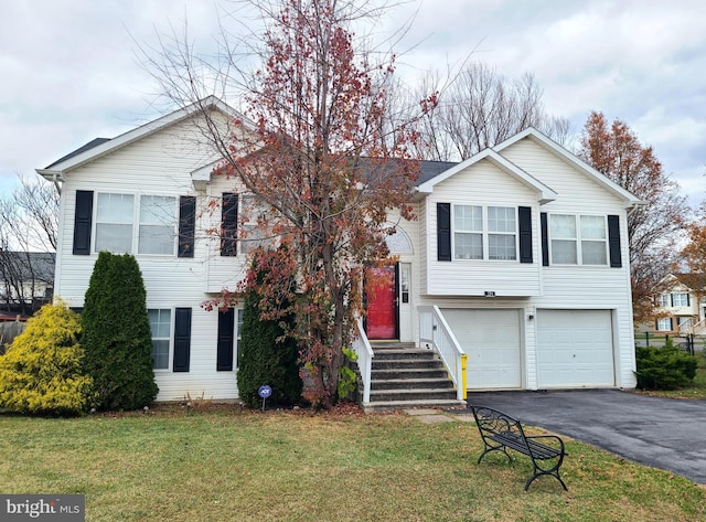 view of front of home with a front lawn and a garage