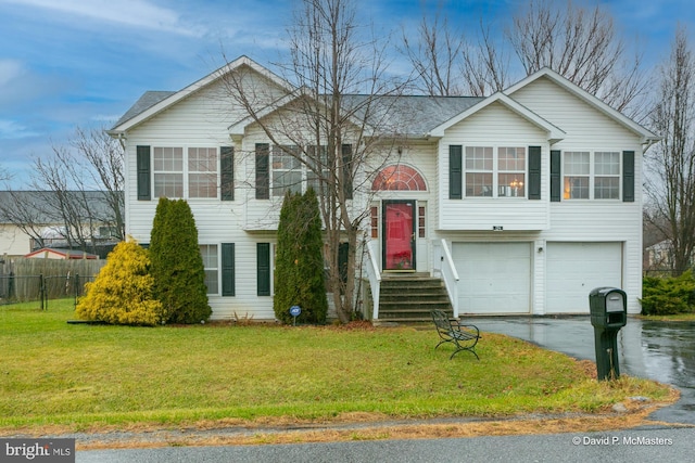 split foyer home with a front yard and a garage