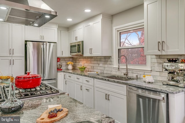 kitchen featuring white cabinets, stainless steel appliances, island range hood, and sink