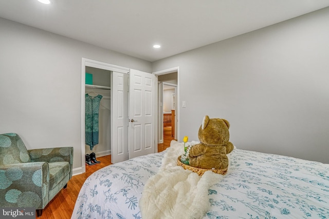 bedroom with a closet and hardwood / wood-style floors