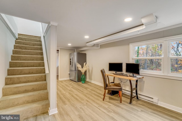 office with light hardwood / wood-style floors and baseboard heating