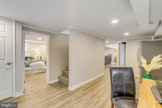 office space featuring crown molding and light hardwood / wood-style flooring