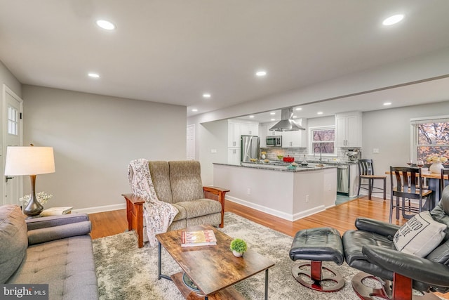 living room with light wood-type flooring and sink