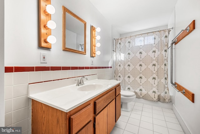 full bathroom with tile patterned flooring, vanity, tile walls, and toilet