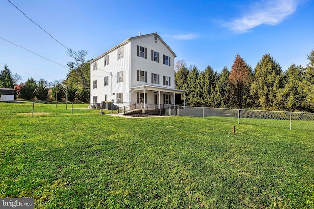 rear view of property with a lawn