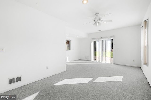 spare room featuring light carpet and ceiling fan