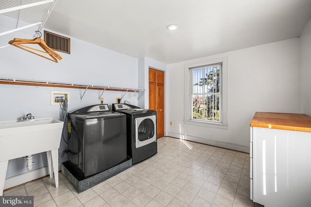 washroom featuring washer and dryer and sink