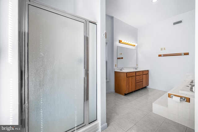 bathroom with tile patterned floors, vanity, and separate shower and tub