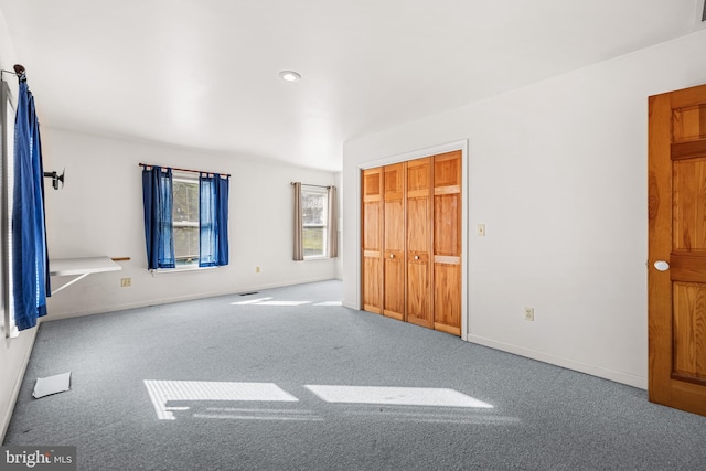 unfurnished bedroom featuring carpet floors and a closet