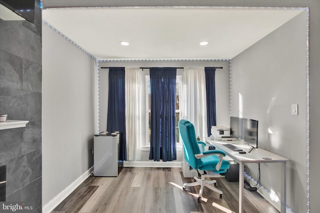 office space with hardwood / wood-style floors and tile walls