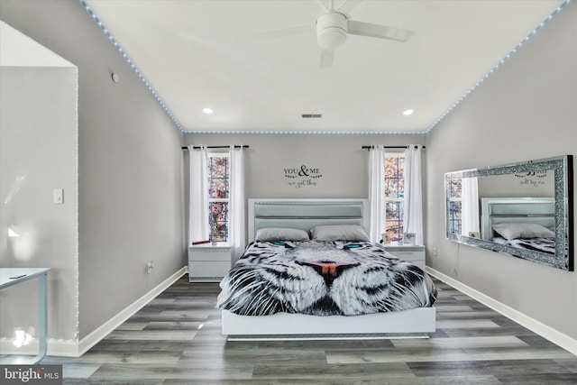 bedroom with vaulted ceiling, ceiling fan, and dark hardwood / wood-style floors