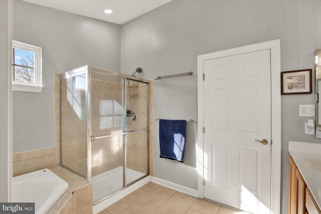 bathroom featuring tile patterned floors, vanity, and independent shower and bath