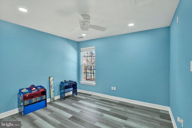 recreation room featuring light hardwood / wood-style floors and ceiling fan