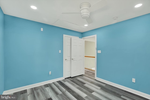 unfurnished bedroom featuring wood-type flooring and ceiling fan