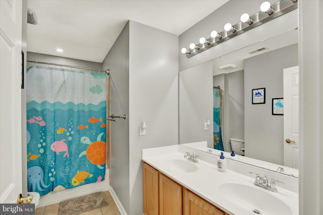 full bathroom with tile patterned floors, vanity, toilet, and shower / bath combo