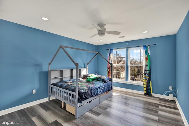 bedroom with ceiling fan and wood-type flooring