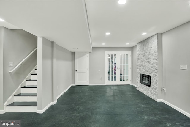 basement with a fireplace and french doors