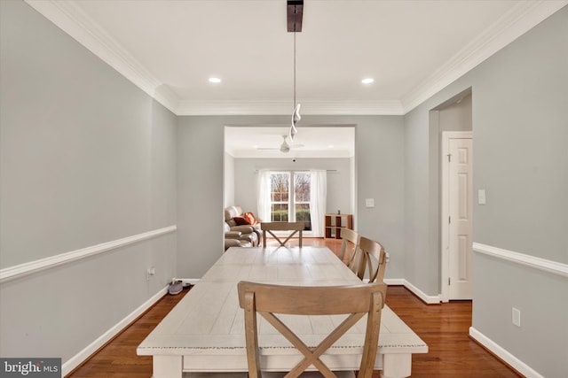 dining area with hardwood / wood-style flooring and ornamental molding