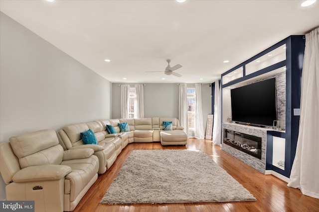 living room featuring ceiling fan and light wood-type flooring