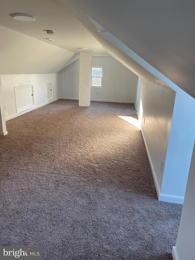 bonus room with carpet floors and lofted ceiling