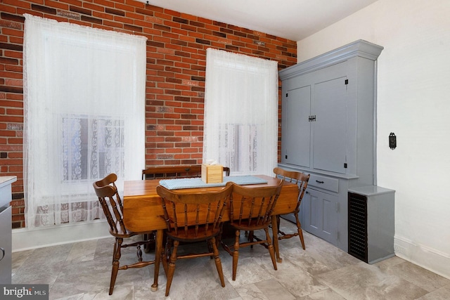 dining space with brick wall