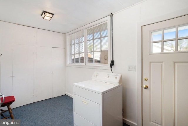 clothes washing area featuring dark carpet and washer / dryer