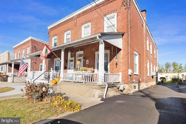 view of property featuring covered porch