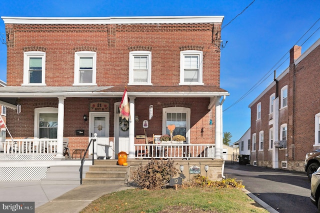 townhome / multi-family property with a porch