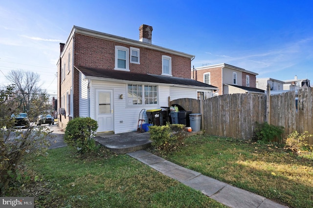 rear view of house with a yard