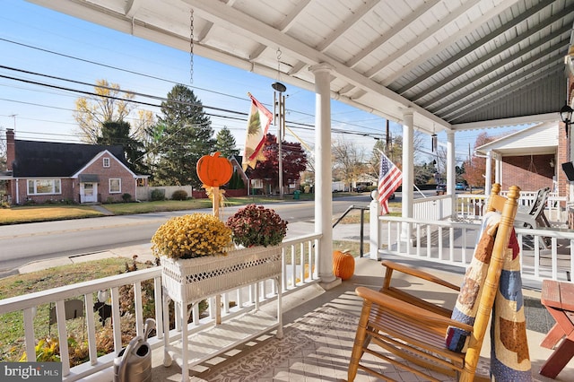 wooden terrace with a porch