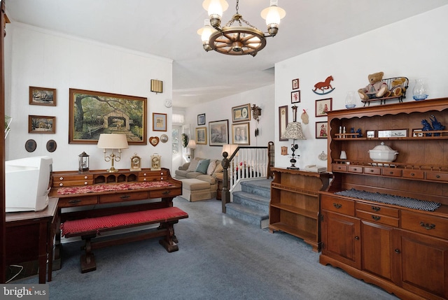 sitting room featuring carpet flooring, a chandelier, and ornamental molding