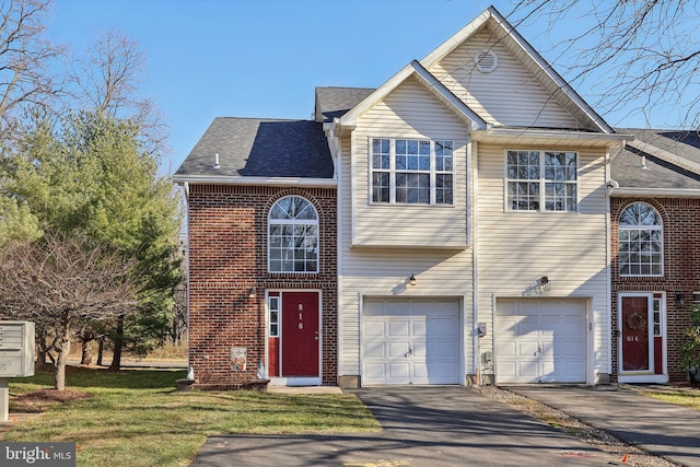 view of front of home with a garage and a front lawn